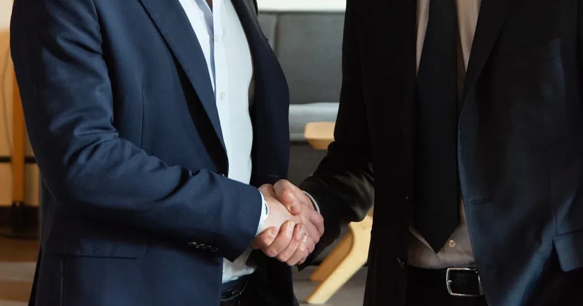 Two business partners shaking hands in agreement.