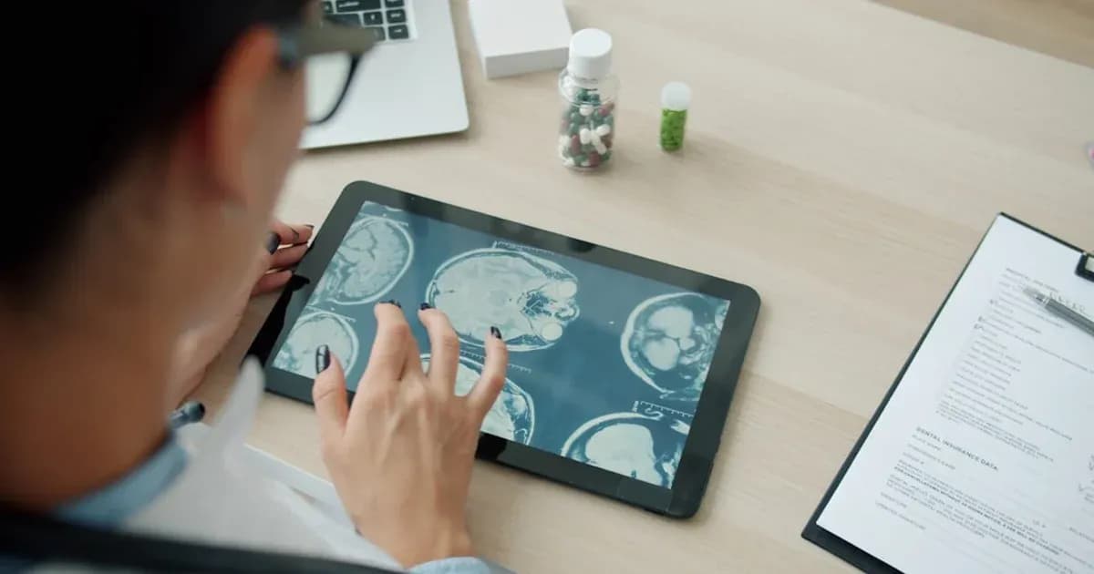 Doctor examining mri scans on a tablet screen