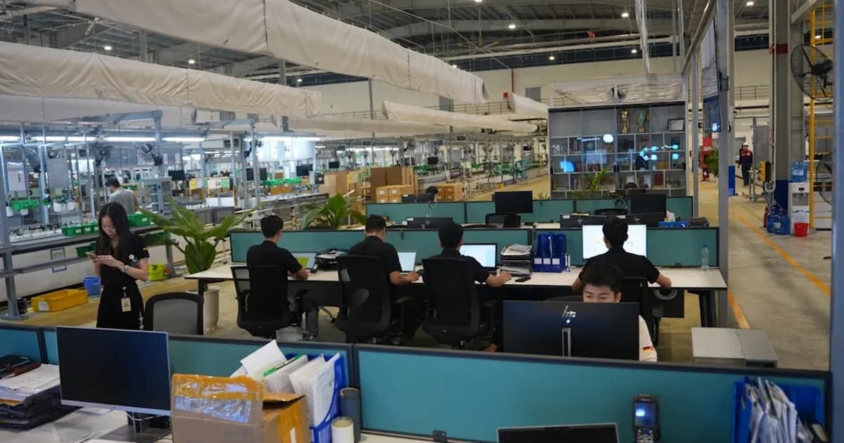 People working at computers in a modern office space.